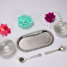 Serving set with silver bowls and spoons.